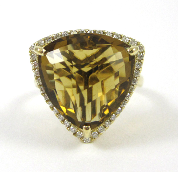 Appraisal: GOLDEN TOPAZ AND FOURTEEN KARAT GOLD RING with round-cut diamonds