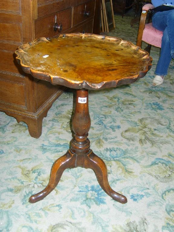 Appraisal: A Georgian walnut occasional table with circular piecrust border baluster