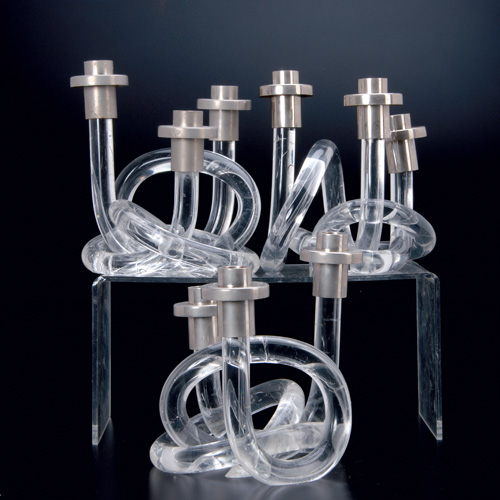 Appraisal: DOROTHY THORPE Set of three lucite and chrome triple candlesticks