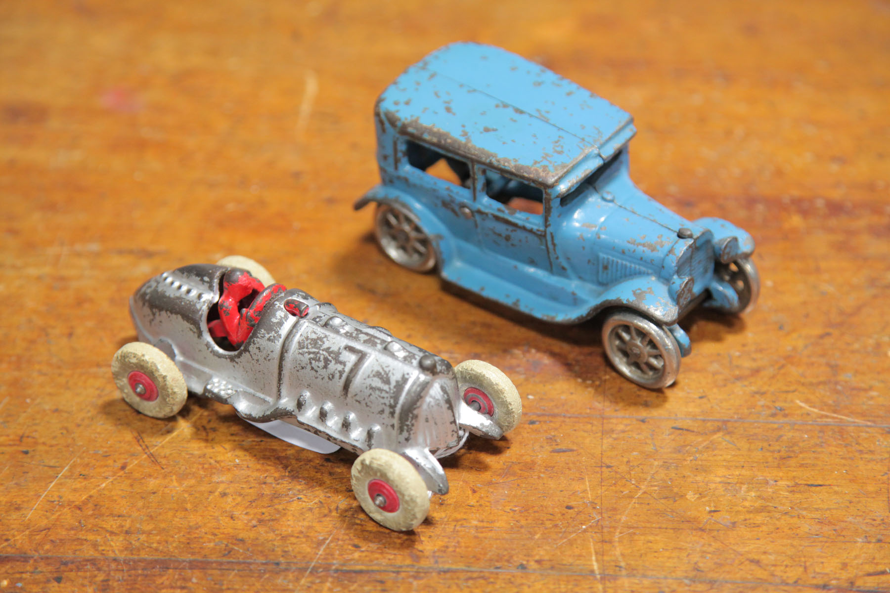 Appraisal: TWO CAST IRON AUTOMOBILES American early th century A silver