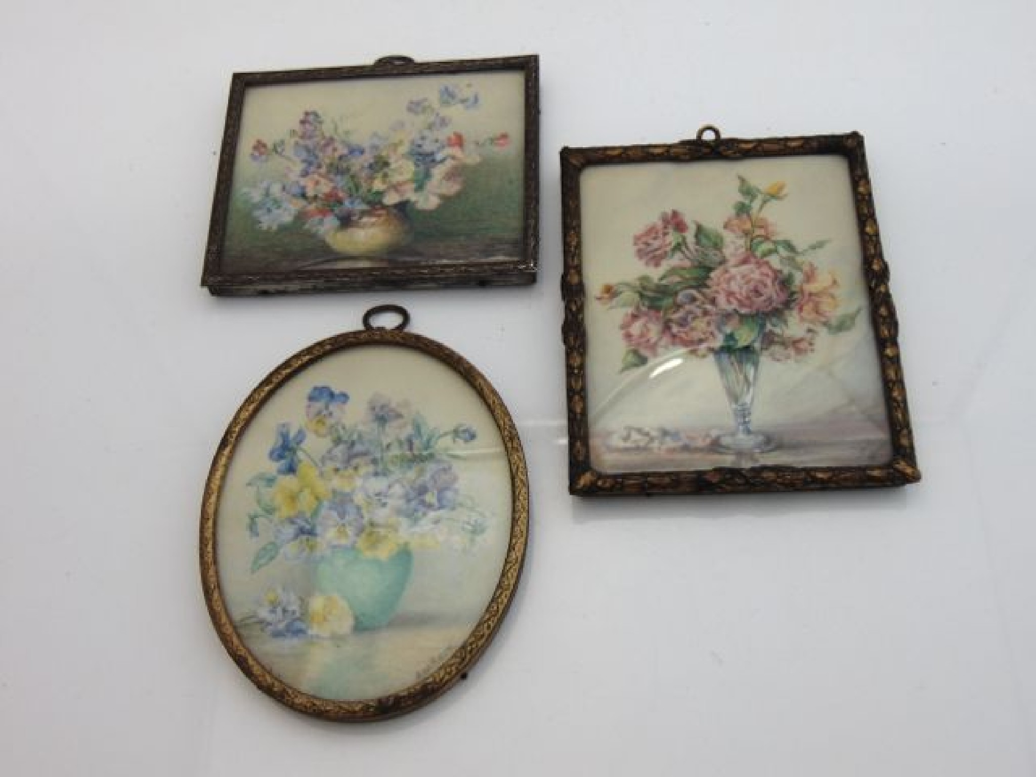 Appraisal: Three miniature paintings on ivory panels all floral subjects one