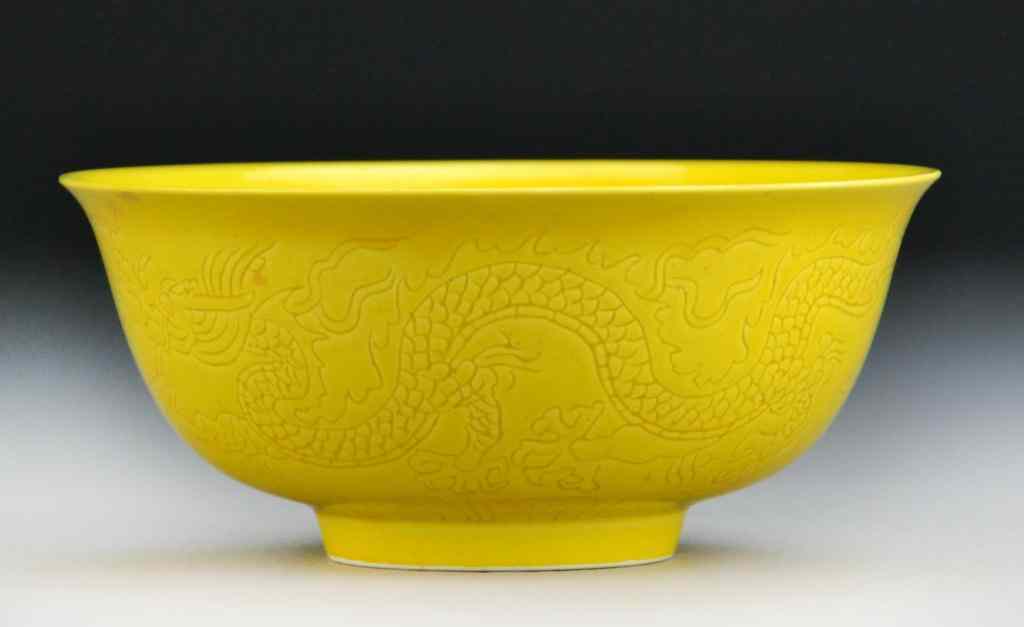 Appraisal: Chinese Qing Lemon Yellow BowlFinely incised with dragon and phoenix