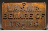 Appraisal: CAST IRON TRAIN SIGN L S W R The rounded