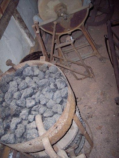 Appraisal: An iron framed brazier and bellows of drum form and