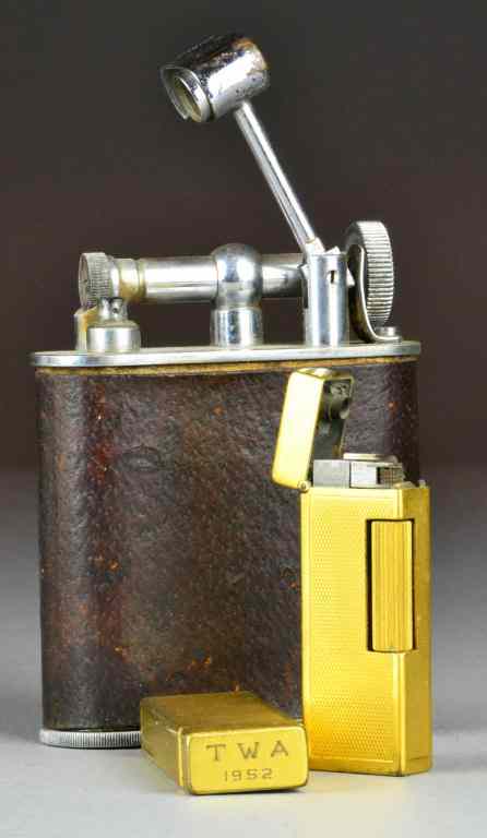 Appraisal: Cigarette Lighters Incl Jumbo and ChurchillTwo Churchil goldtone lighters Made