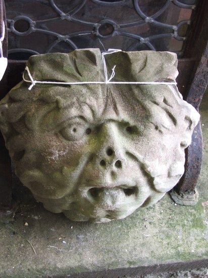 Appraisal: AN ANTIQUE SANDSTONE GARGOYLE in the form of a mask