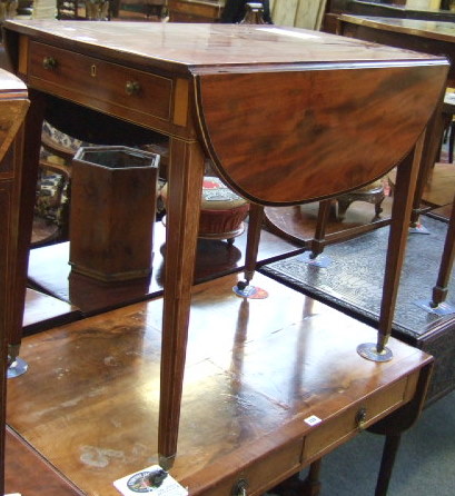 Appraisal: A George III mahogany Pembroke table the cross banded oval