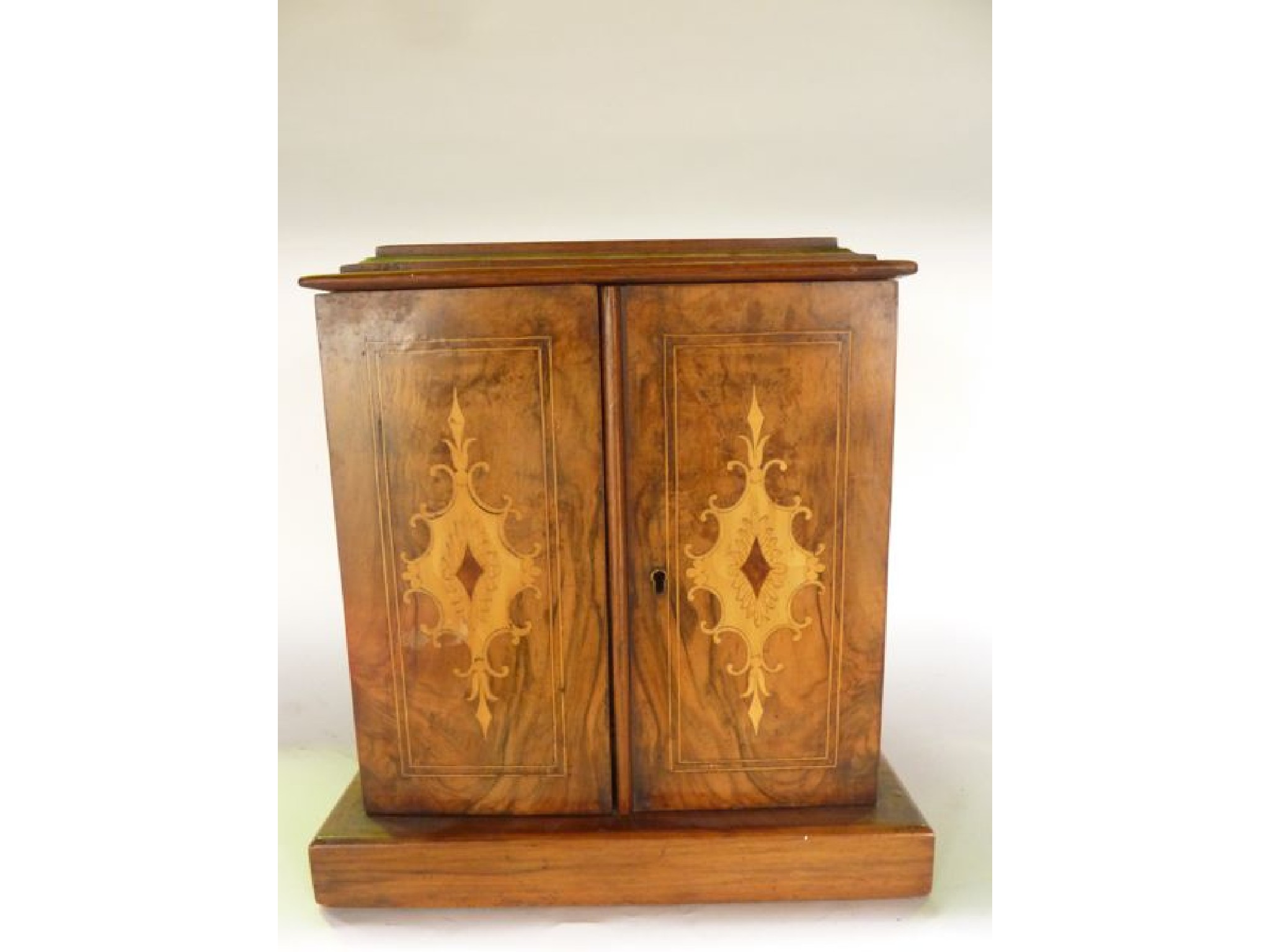 Appraisal: A miniature bank of three drawers principally in walnut enclosed