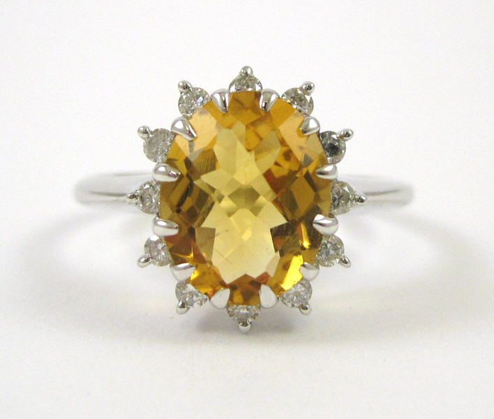 Appraisal: FOURTEEN KARAT WHITE GOLD DIAMOND AND CITRINE RING oval checkerboard-cut