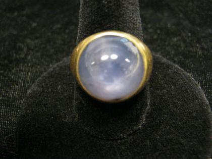 Appraisal: karat yellow gold star sapphire ringSimple yellow gold bombe setting