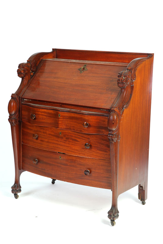 Appraisal: SLANT LID DESK Mahogany with carved lion head sides serpentine