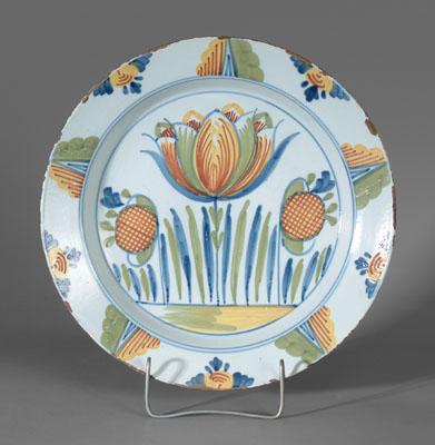 Appraisal: Delft tulip charger vivid polychrome decoration with central tulip flanked