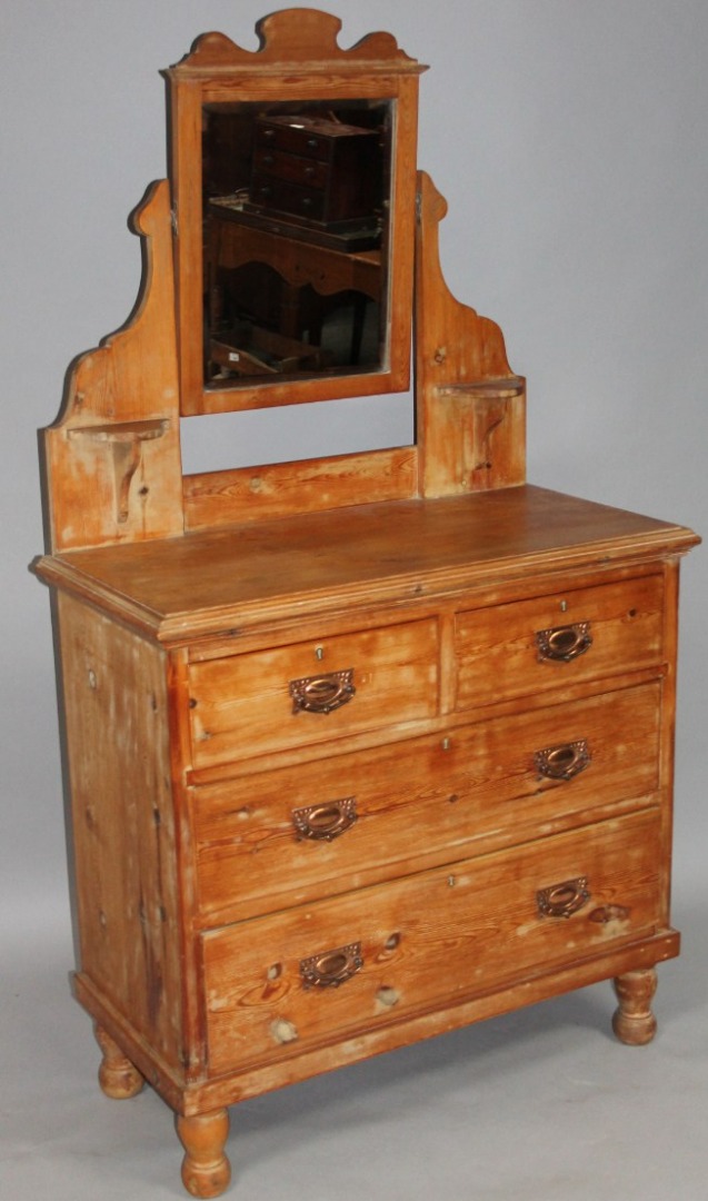 Appraisal: A stripped and lightly polished pine mirror back dressing chest