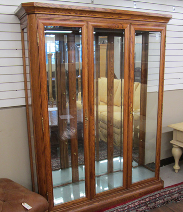 Appraisal: LARGE OAK AND BEVELED GLASS CHINA DISPLAY CABINET Trend Manor