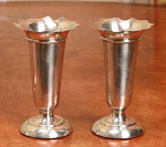 Appraisal: A PAIR OF SILVER TRUMPET VASES with shaped edges and