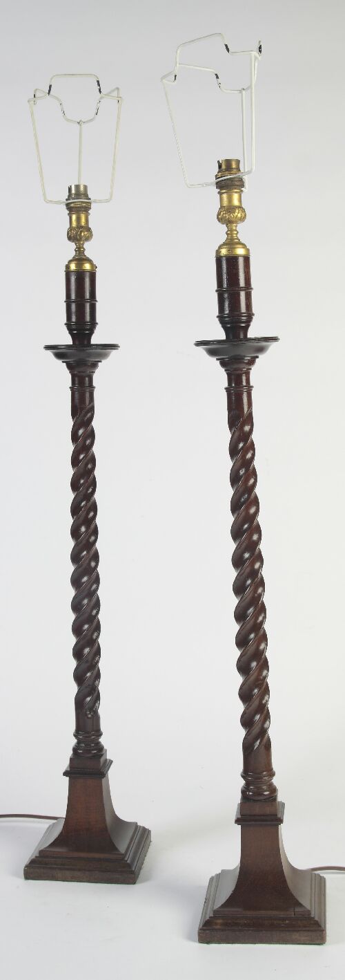 Appraisal: A pair of tall oak and mahogany table lamps each