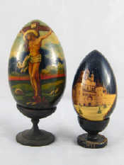 Appraisal: Two Russian solid wooden eggs one with crucifixion scene ht