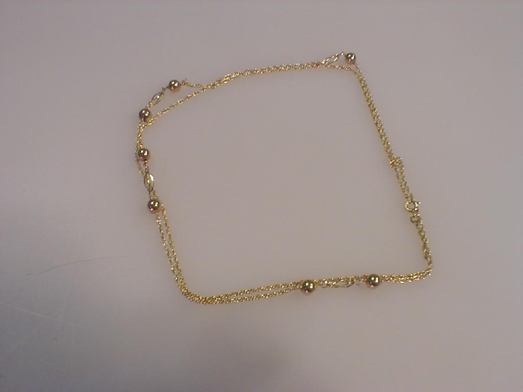 Appraisal: A yellow metal neck chain of rope links with ball