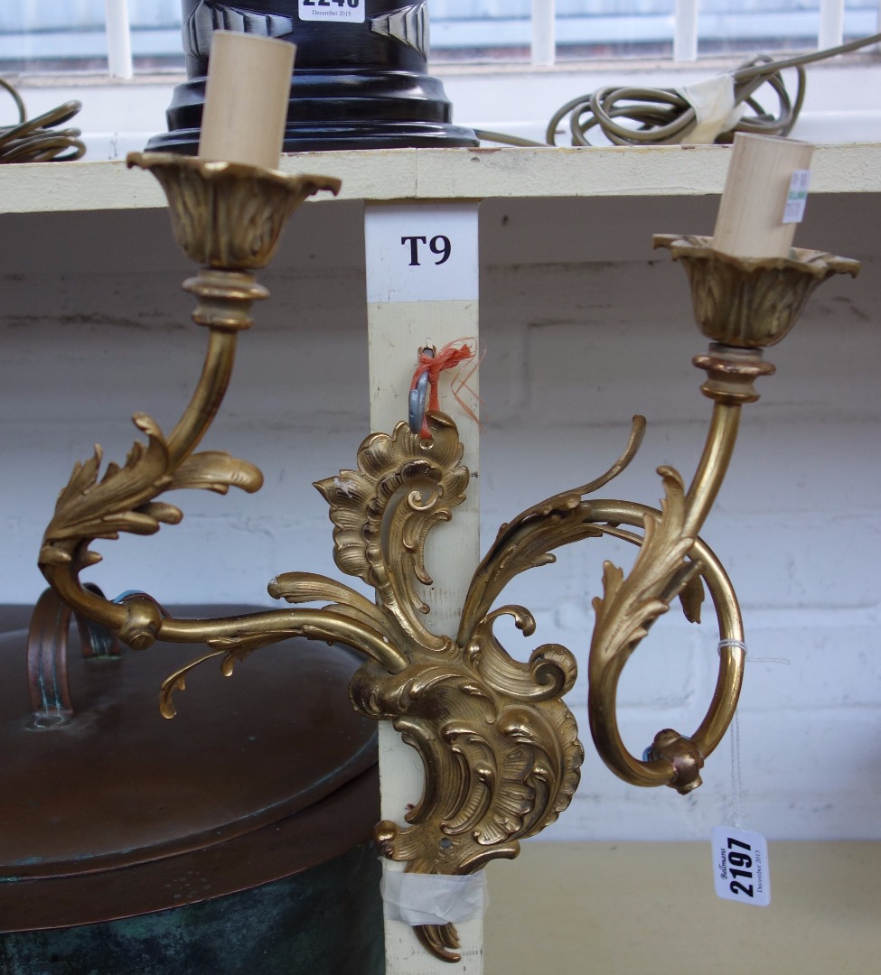 Appraisal: A pair of gilt brass twin branch wall appliques of