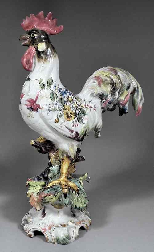 Appraisal: An Italian faience figure of a standing cockerel perched on