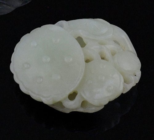 Appraisal: A Chinese celadon jade pebble carving of a water lily