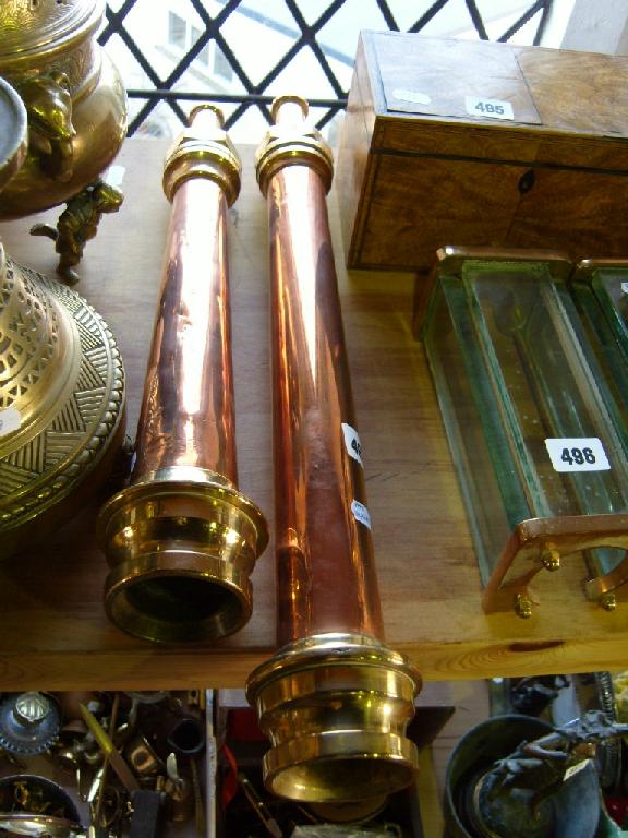 Appraisal: A pair of copper and brass fireman's hose nozzles by