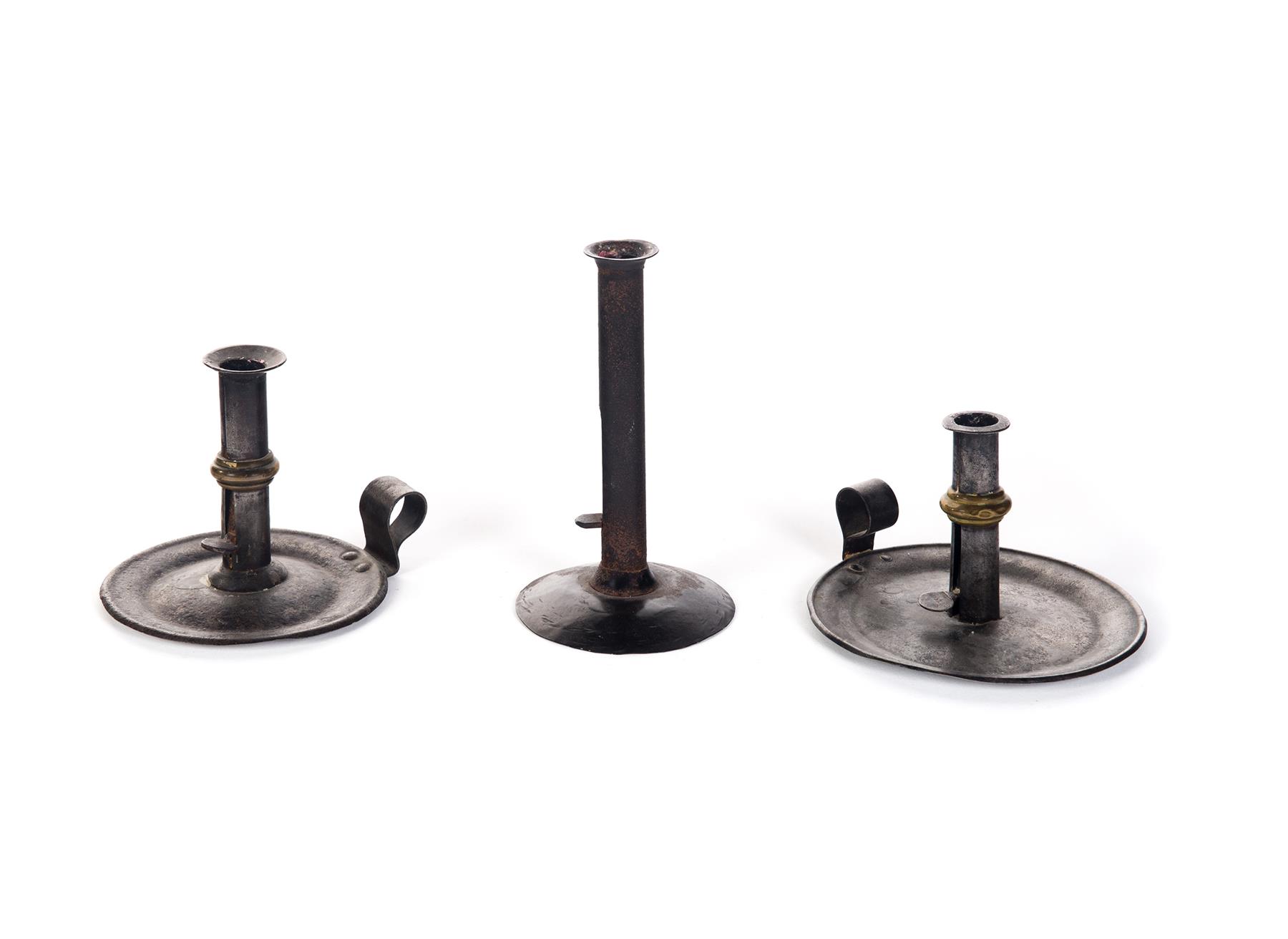 Appraisal: THREE HOGSCRAPER CANDLESTICKS Probably American th century Two chambersticks with