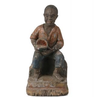 Appraisal: CARVED BLACKIANA FIGURE th c Carved and Painted Wood Seated