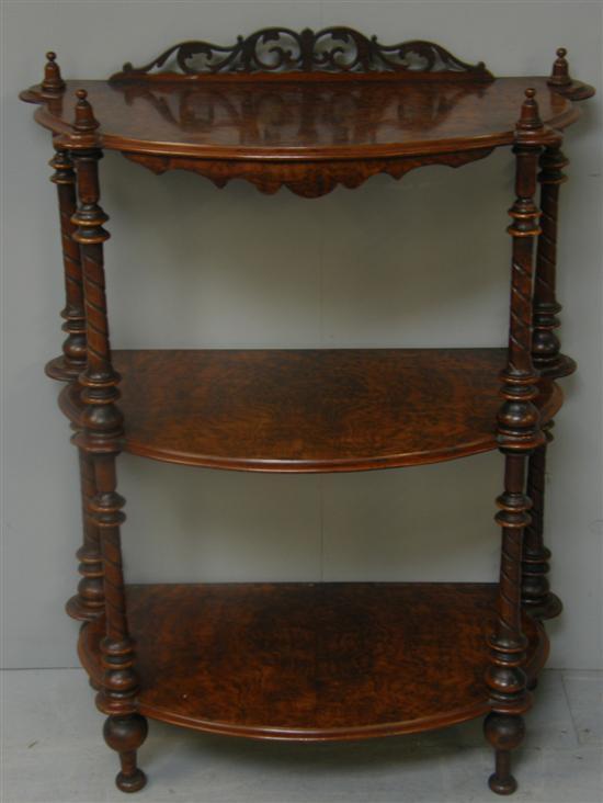 Appraisal: Victorian walnut bow-fronted three tier whatnot with raised and galleried