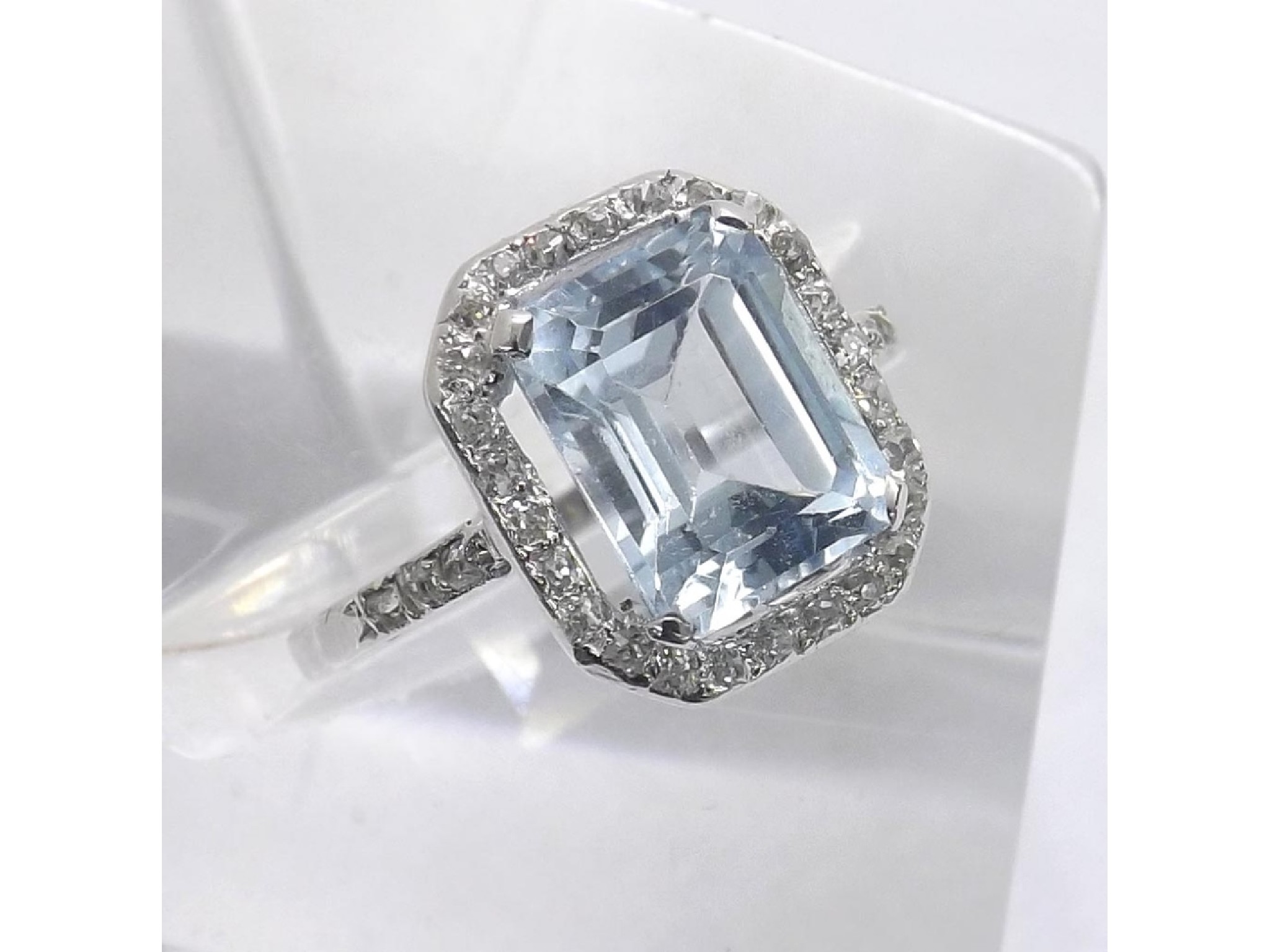 Appraisal: Good platinum blue topaz and diamond cluster ring emerald-cut topaz