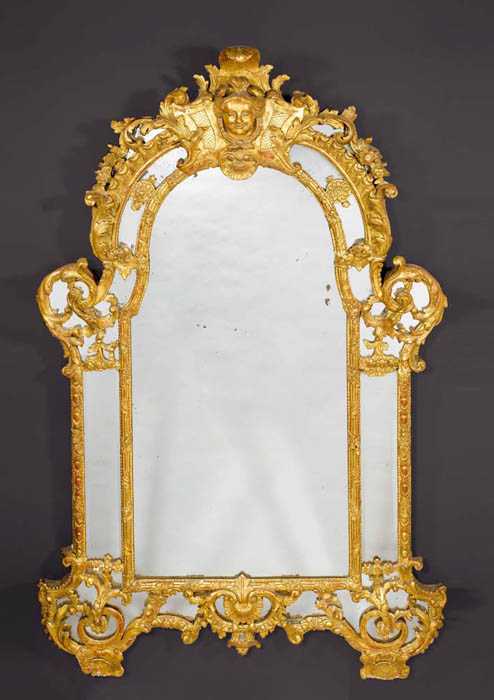 Appraisal: CARVED GILTWOOD MIRROR A LA TETE DE FEMME R gence