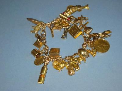 Appraisal: A CT GOLD CHARM BRACELET with thirty three various charms