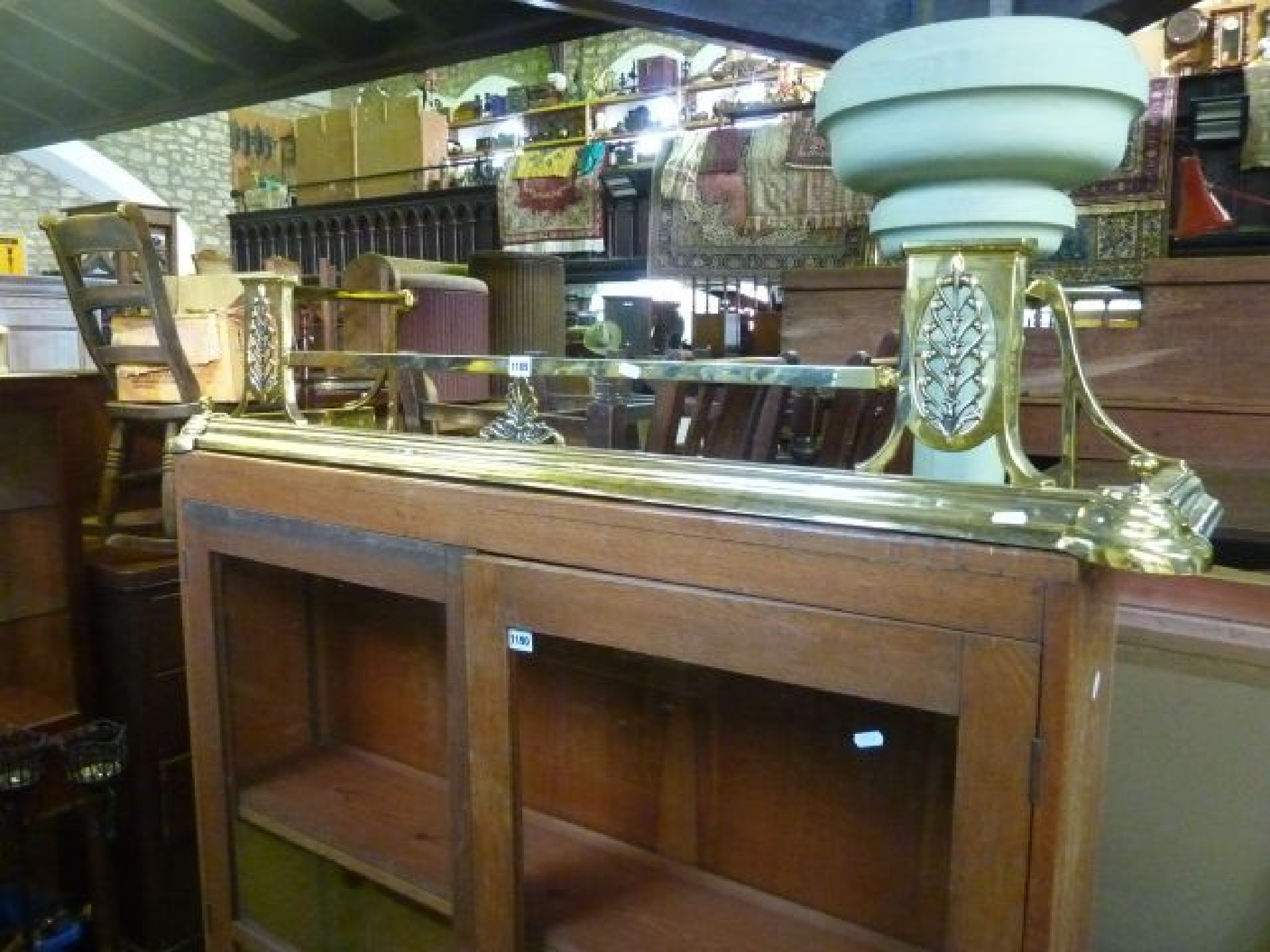 Appraisal: A late Victorian polished brass fender with acanthus detail cm