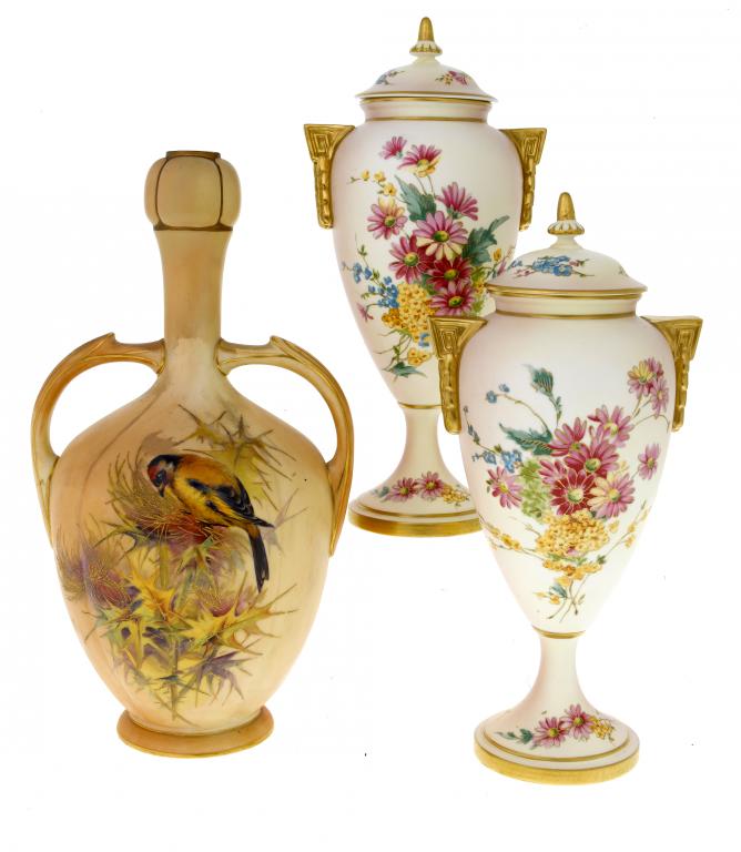 Appraisal: A PAIR OF ROYAL WORCESTER TWO HANDLED VASES AND COVERS