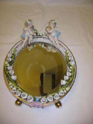 Appraisal: A CONTINENTAL PORCELAIN MIRROR FRAME of oval form the bevelled