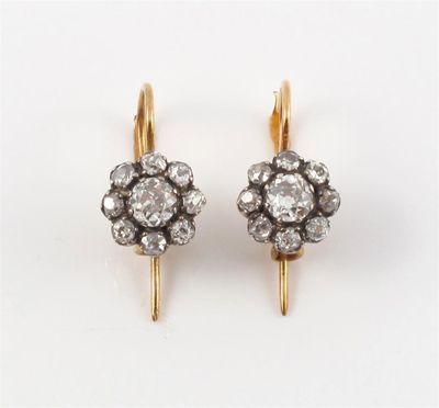 Appraisal: A pair of diamond cluster earrings Each earring set with