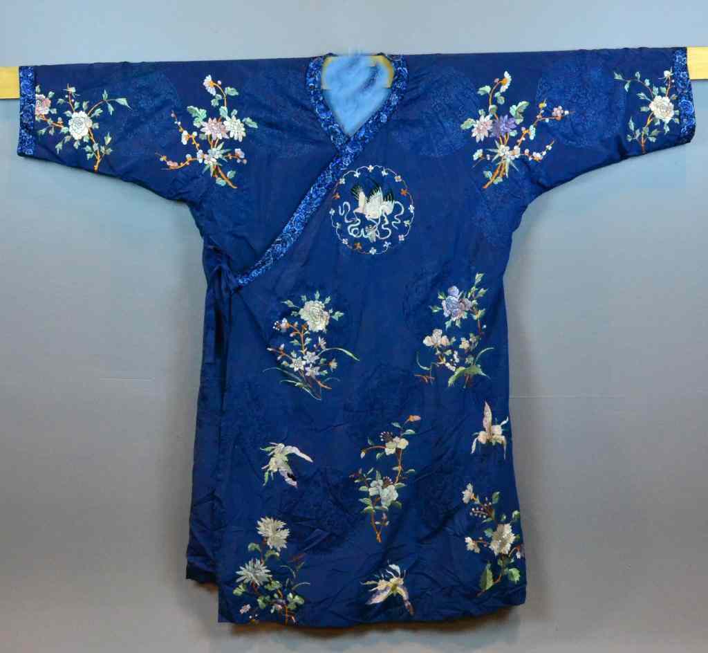 Appraisal: Chinese Silk Embroidered RobeBlue silk robe depicting lotus blossoms butterflies