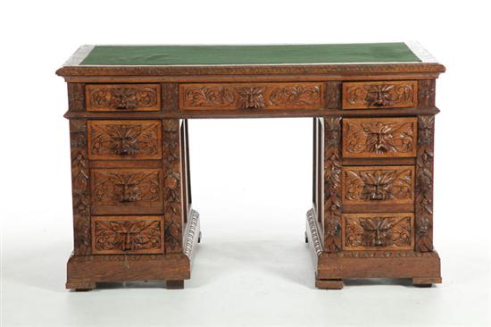 Appraisal: CARVED DESK Early th century oak Highly carved with nine