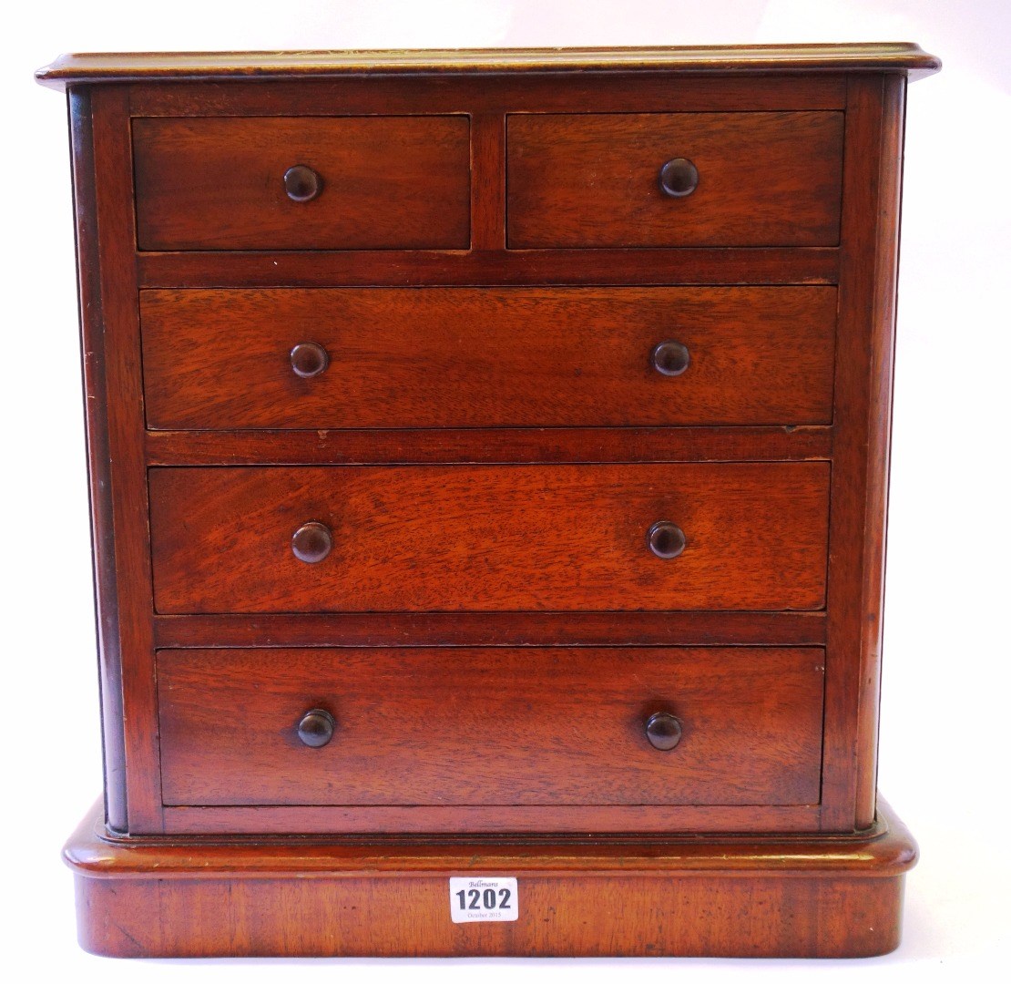 Appraisal: A mahogany miniature chest of two short and three long