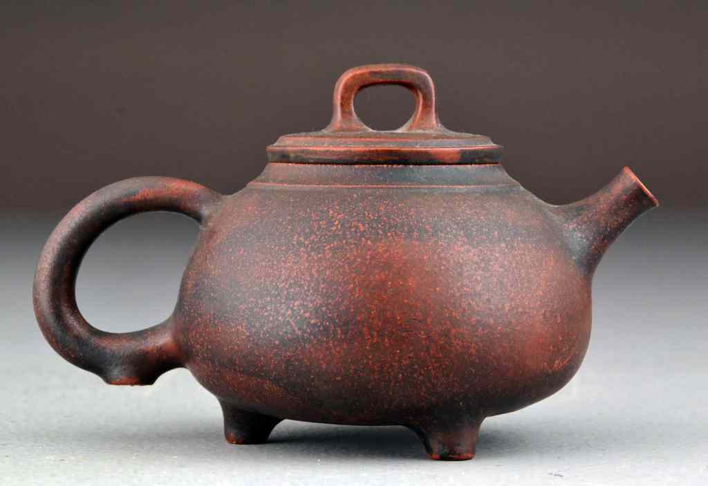 Appraisal: Chinese Qing Yixing Pottery Tea PotOf deep terracotta color raised