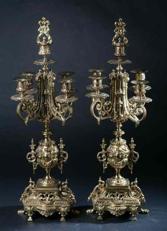 Appraisal: PAIR BAROQUE-STYLE GILT-METAL FIVE-LIGHT CANDELABRA th century Shaped bases raised