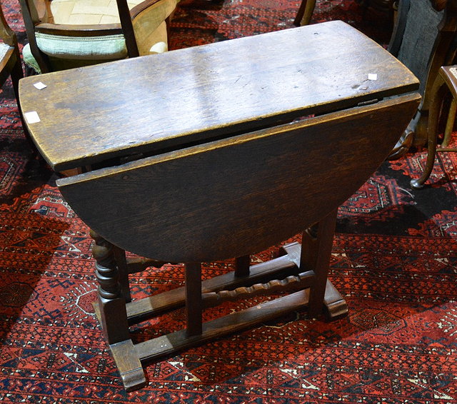 Appraisal: An antique oak gateleg tablewith oval top on barley-twist legs