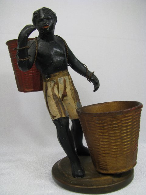 Appraisal: Hand painted metal Black Americana statue of a man carrying