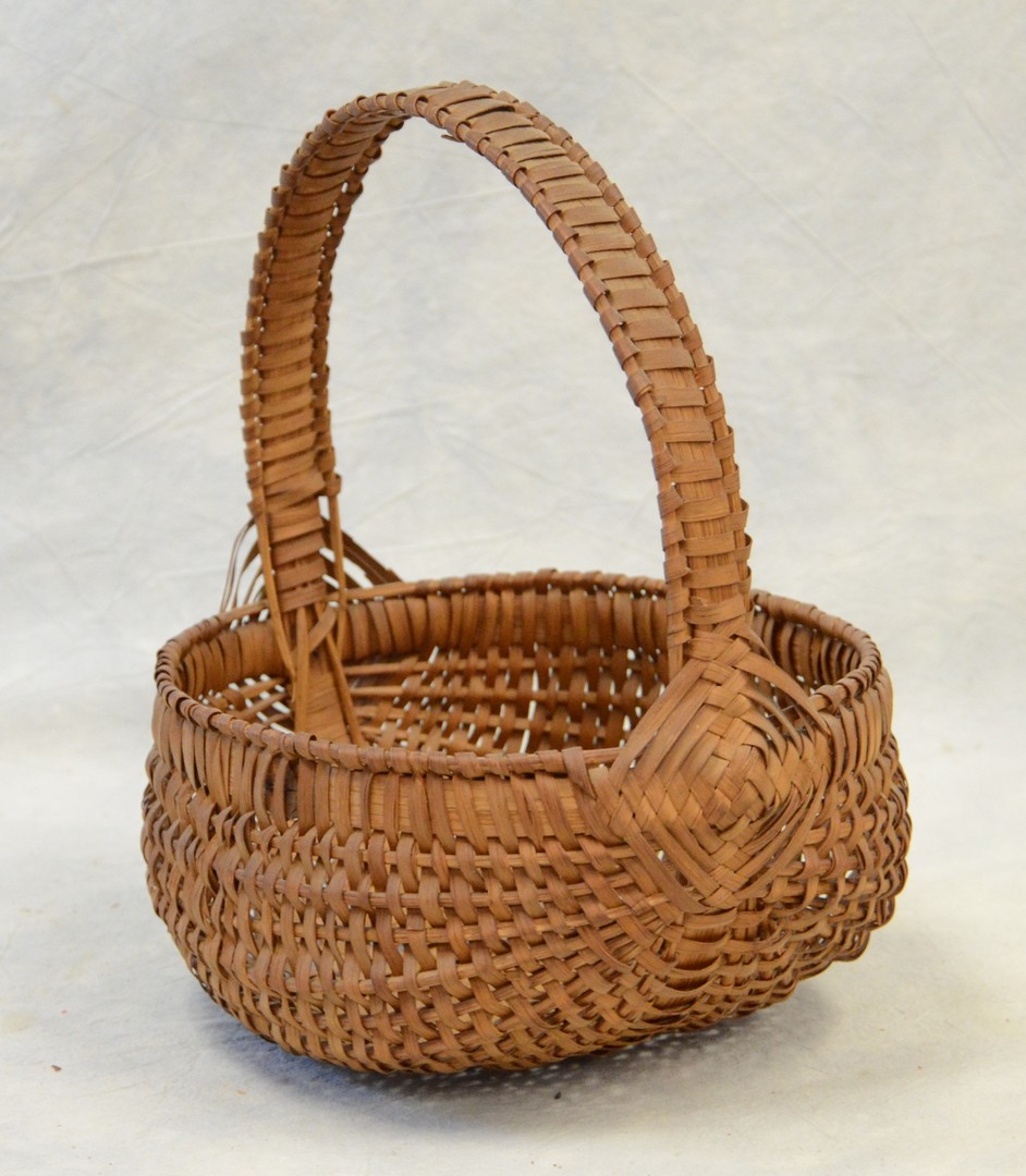 Appraisal: Pennsylvania high handle basket splint woven handle exaggerated Gods eyes