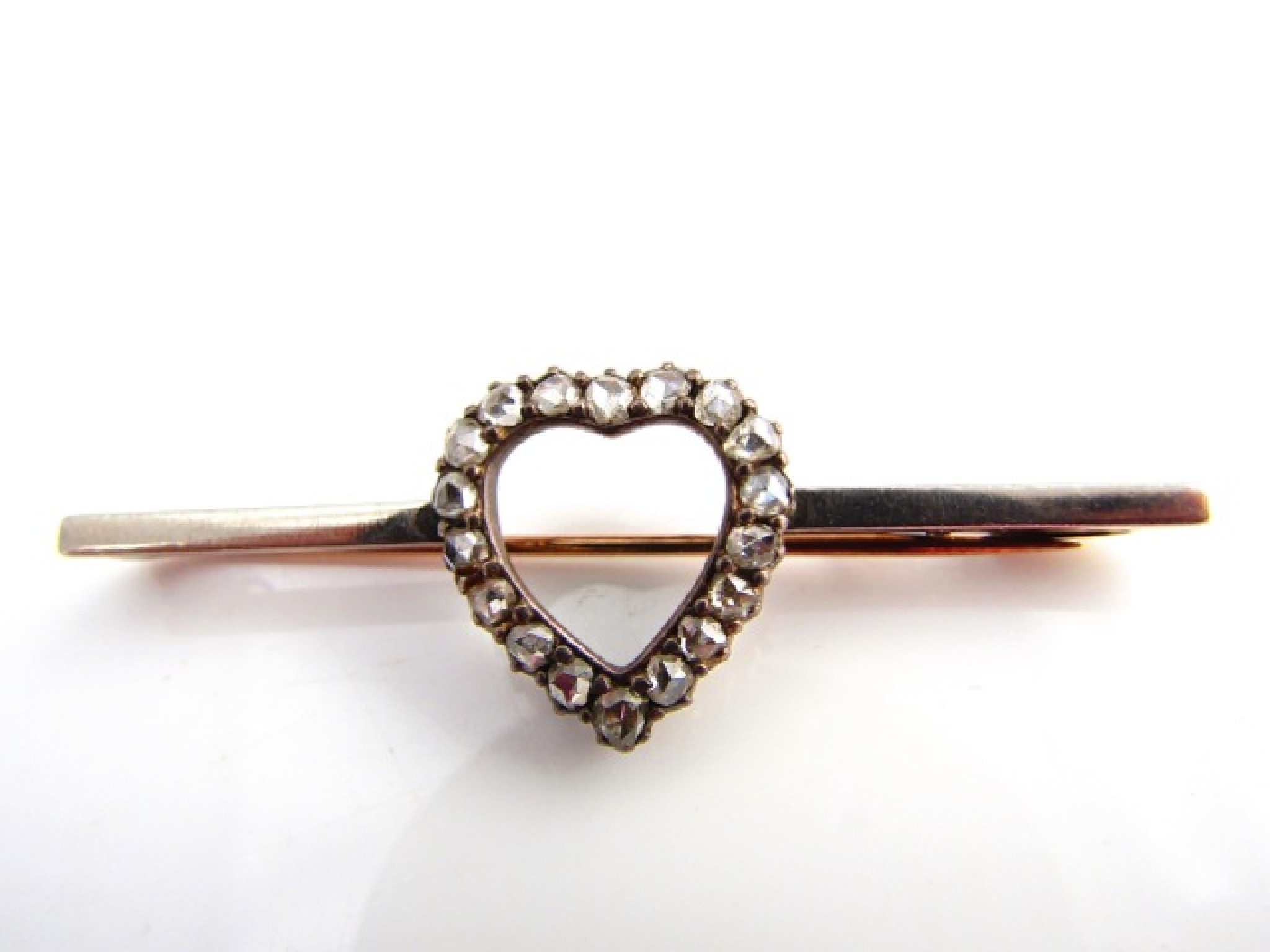 Appraisal: A Victorian diamond bar brooch centred with a heart-shaped motif