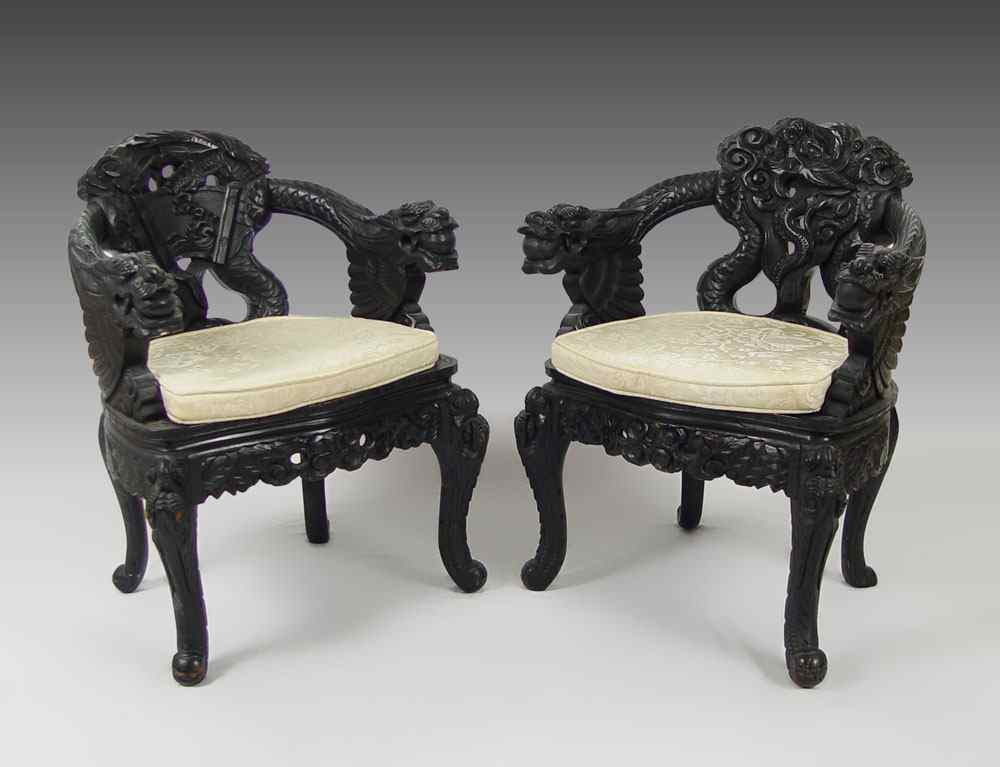 Appraisal: PAIR CHINESE CARVED DRAGON CHAIRS Ebony finish The backs are