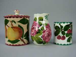 Appraisal: A Wemyss cylindrical biscuit barrel decorated with peaches and foliage