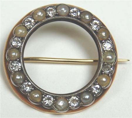 Appraisal: An Edwardian open circular brooch alternately set with a border