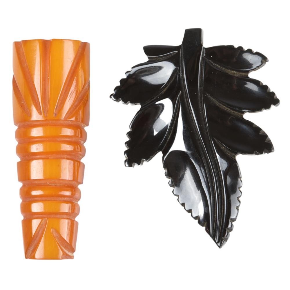 Appraisal: TWO BAKELITE DRESS CLIPS BUTTERSCOTCH TIKI TOTEM CLIP AND BLACK