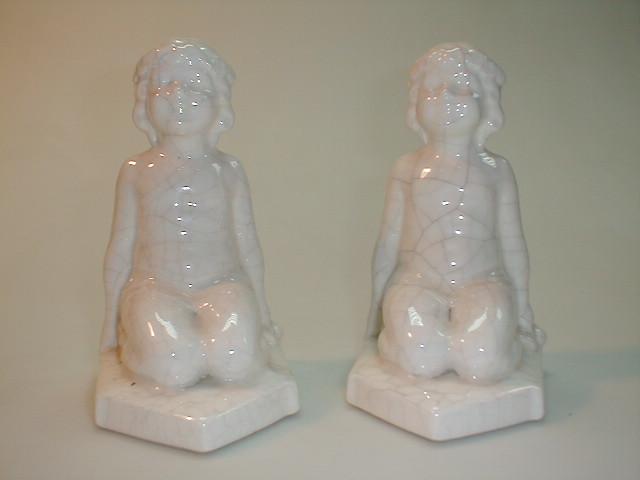 Appraisal: A pair of pottery white crackle glaze bookends modelled as